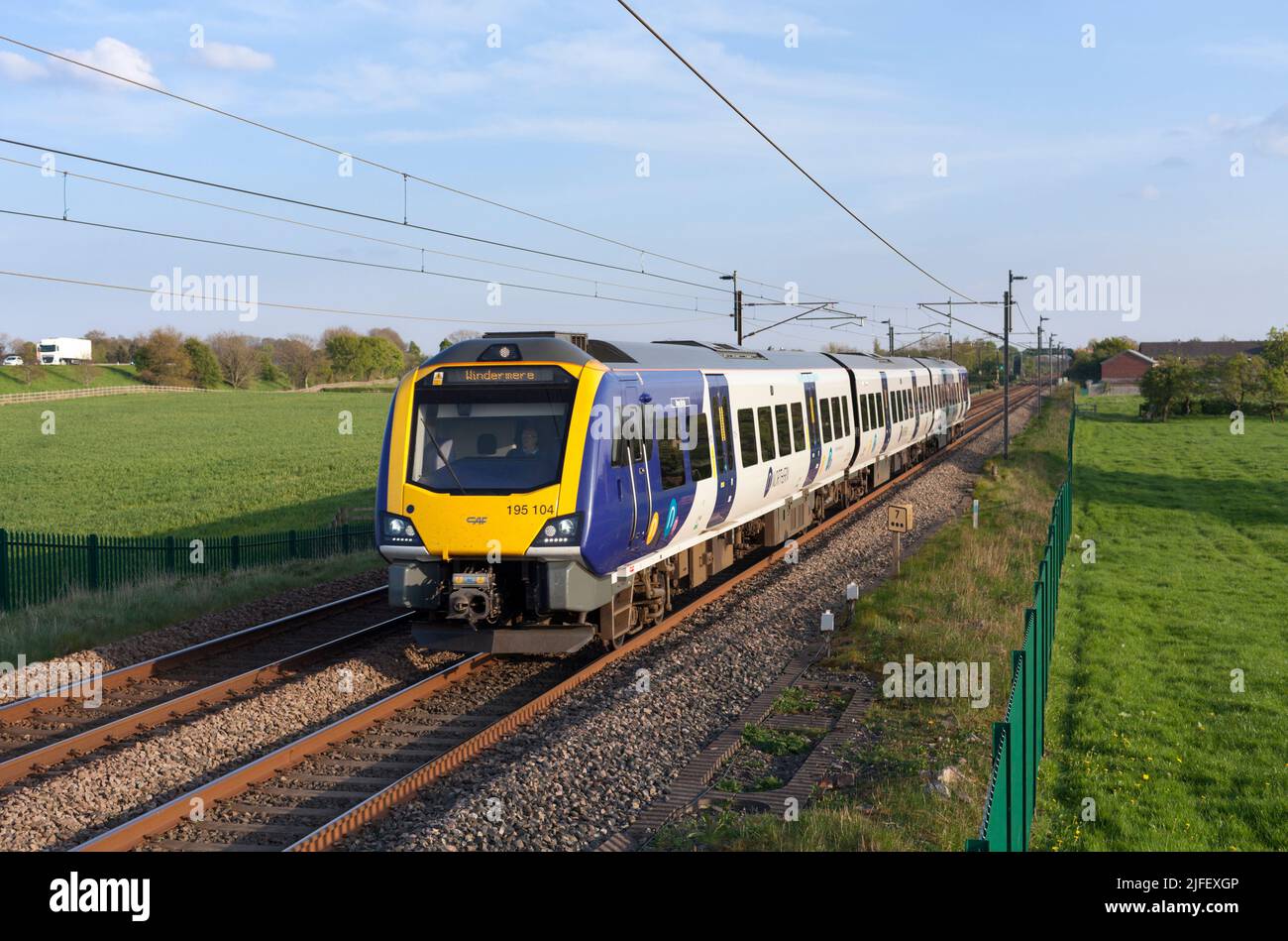 Northern rail class 195 CAF Civity diesel train on the electrified  west coast mainline railway line Stock Photo