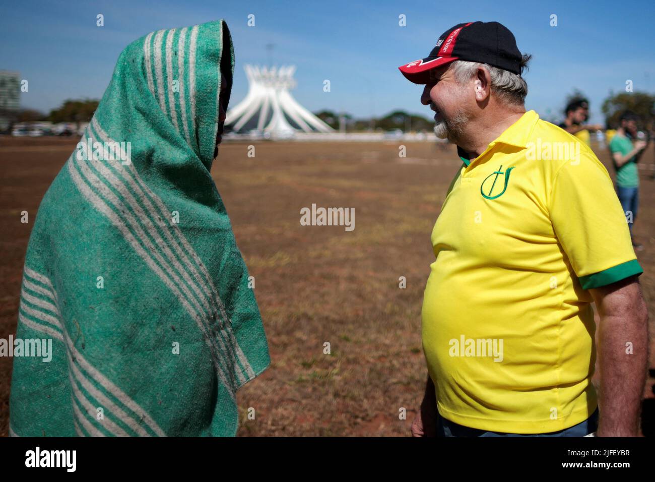 A man talks with a homeless person during an Evangelical March for Jesus in Brasilia, Brazil July 2, 2022. REUTERS/Ueslei Marcelino Stock Photo