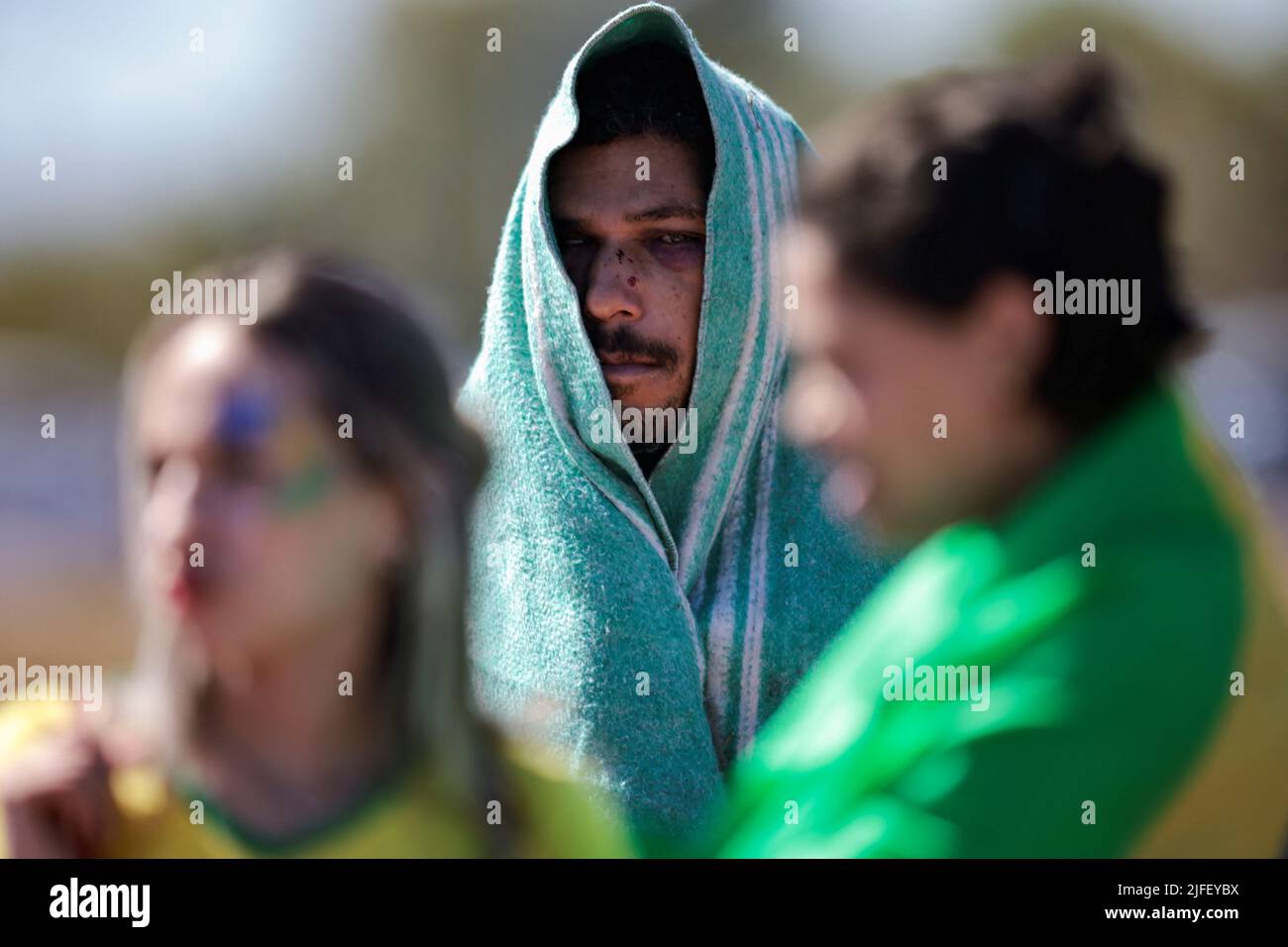 A homeless person observes an Evangelical March for Jesus in Brasilia, Brazil July 2, 2022. REUTERS/Ueslei Marcelino     TPX IMAGES OF THE DAY Stock Photo