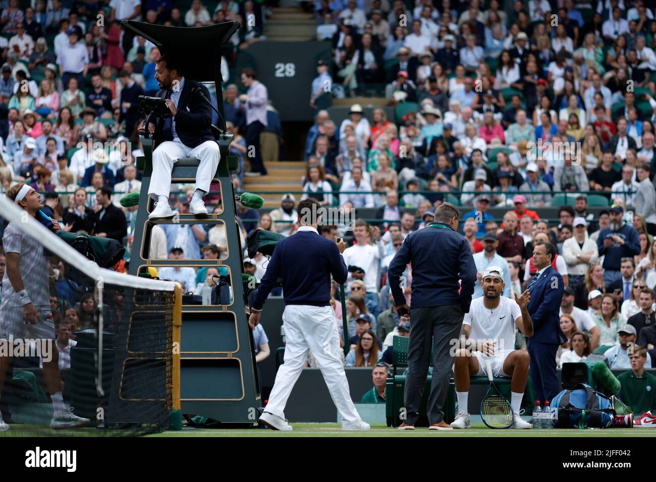 Nick Kyrgios (right) speaks an official after the second set as Stefanos Tsitsipas (left) speaks to the umpire during their Men's Singles third round match during day six of the 2022 Wimbledon Championships at the All England Lawn Tennis and Croquet Club, Wimbledon. Picture date: Saturday July 2, 2022. Stock Photo