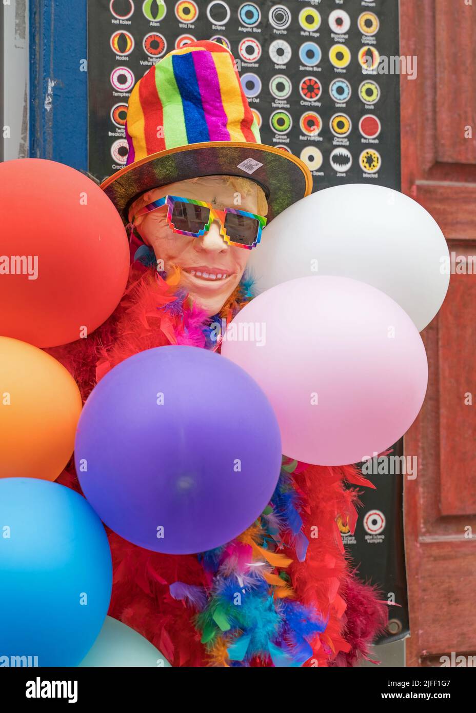 Fancy dress shop decorated with bright coloured flags and decorations. London Stock Photo