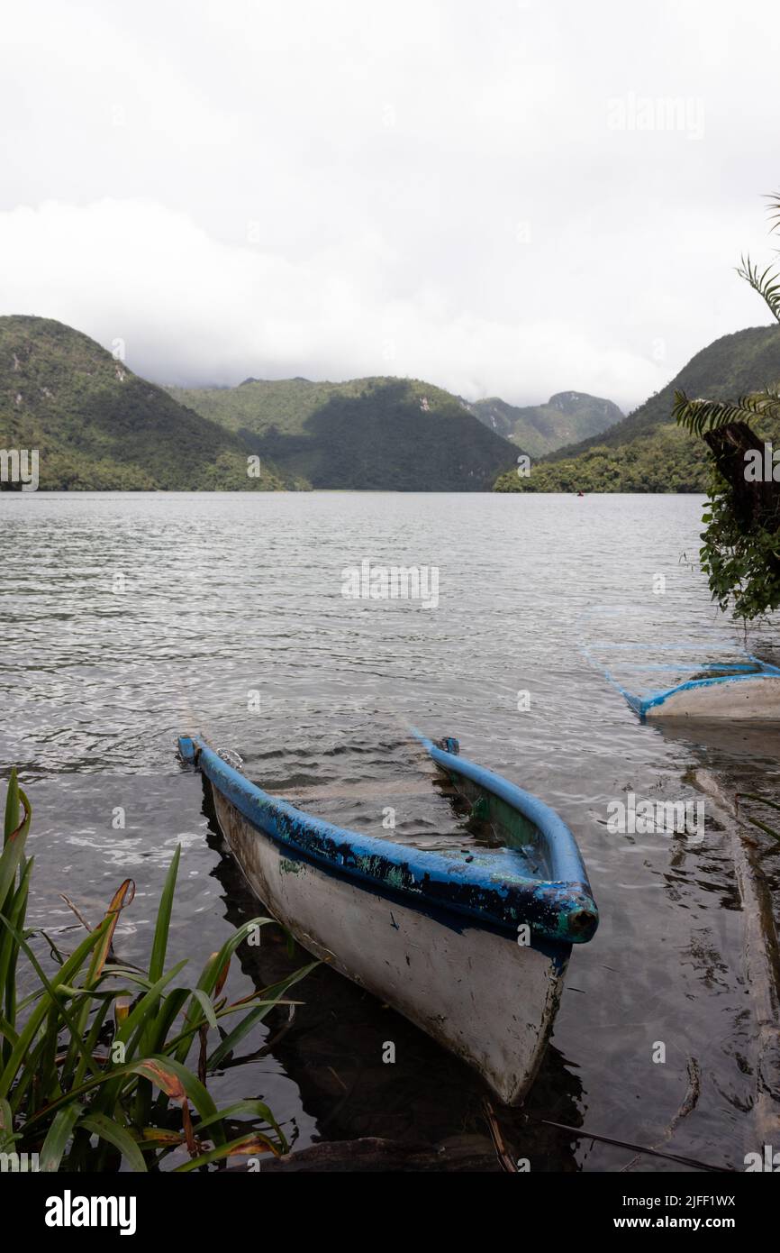 A vertical shot of an old abandoned boat in the lake Laguna Brava, Huehuetenango, Guatemala Stock Photo