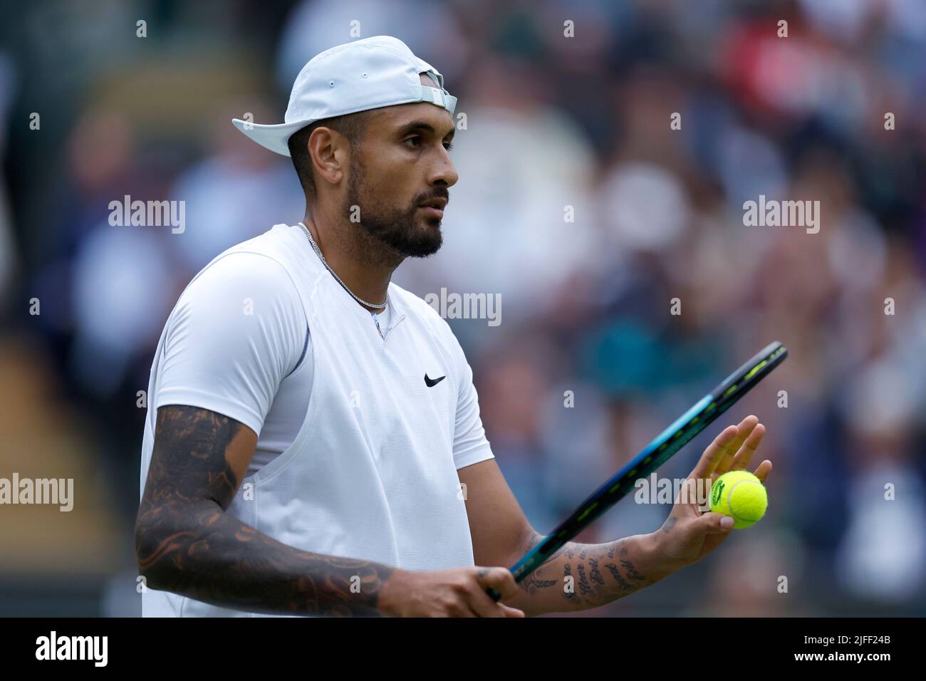 Nick Kyrgios apologies for clipping the net during his Men's Singles third round match against Stefanos Tsitsipas during day six of the 2022 Wimbledon Championships at the All England Lawn Tennis and Croquet Club, Wimbledon. Picture date: Saturday July 2, 2022. Stock Photo