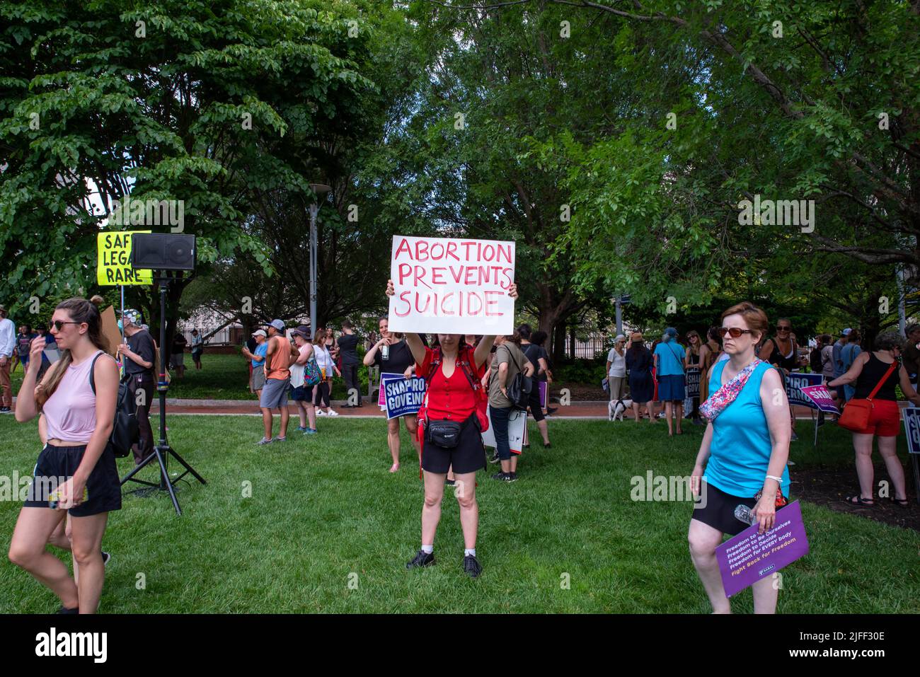 Woman at pro-choice rally holds feminist protest sign ABORTION PREVENTS SUICIDE Stock Photo