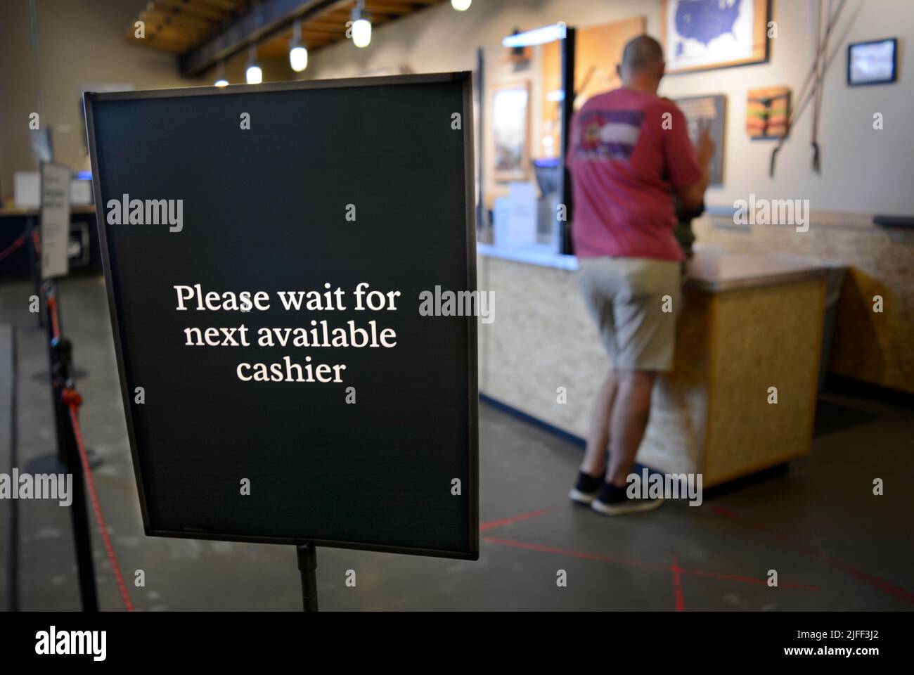 A customer makes a purchase at an REI (Recreational Equipment Inc
