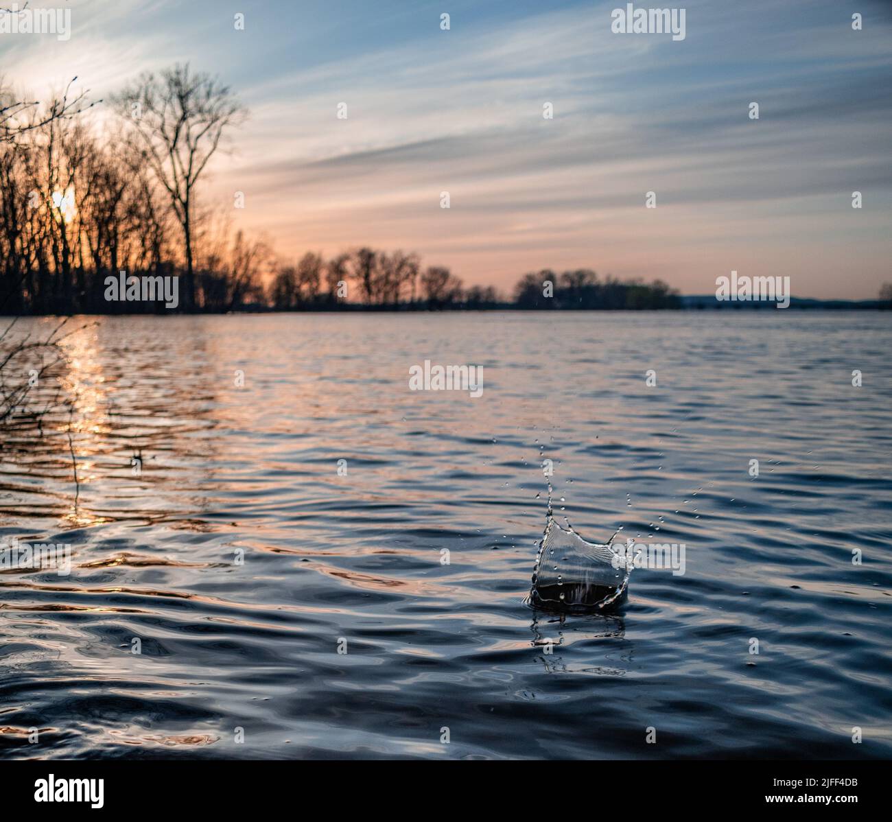 Mesmerizing view of a sunset in summer landscape, lake surrounded by ...