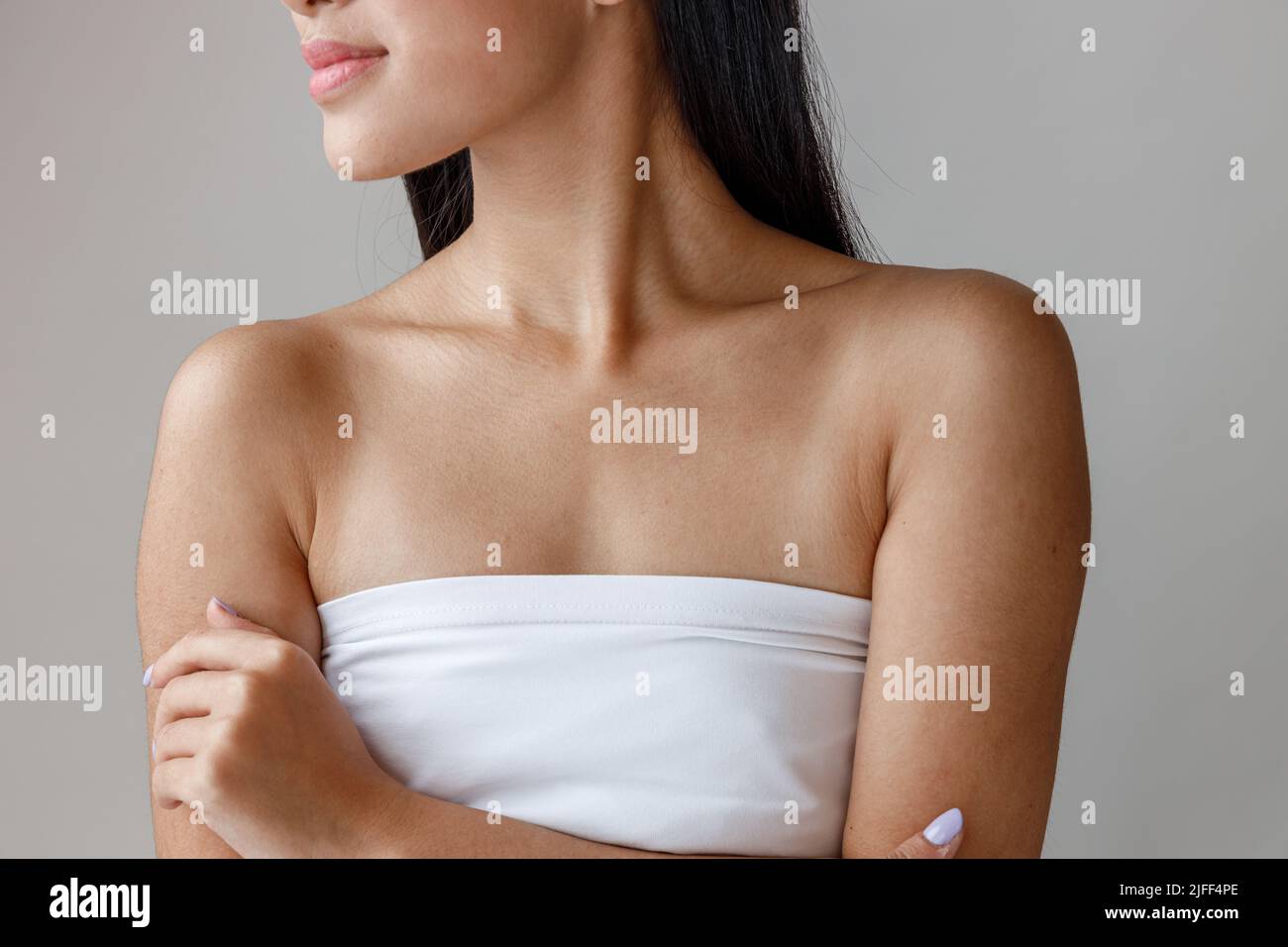Asian young woman with perfect skin standing in studio Stock Photo