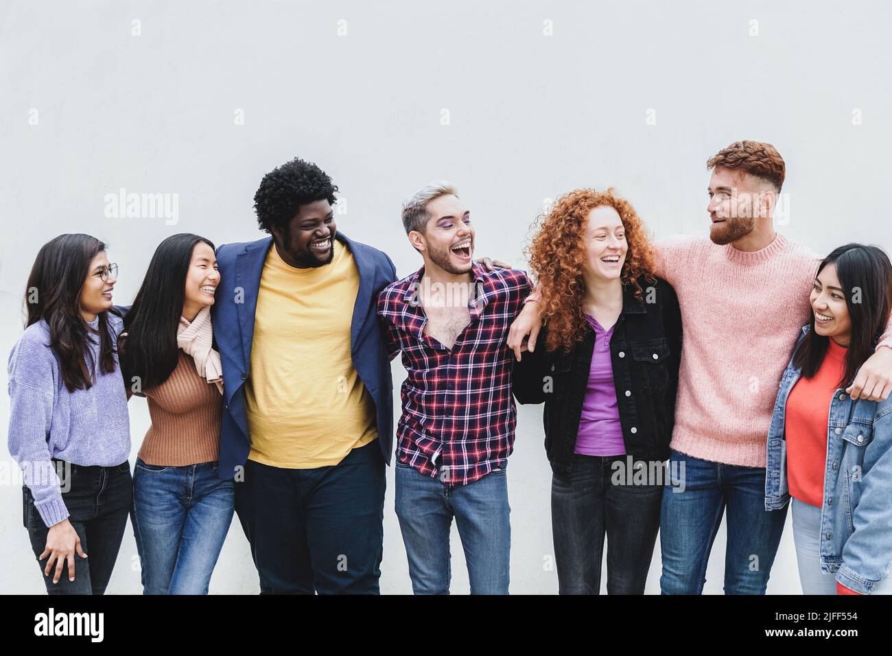 Diverse group of friends having fun together outdoor - Focus on gay man wearing makeup Stock Photo