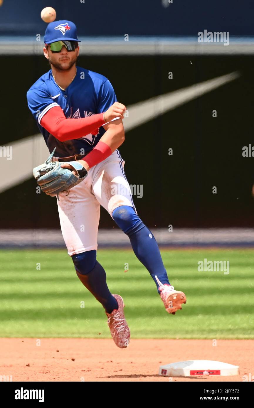 Toronto Blue Jays' shortstop Bo Bichette throws to first base to put