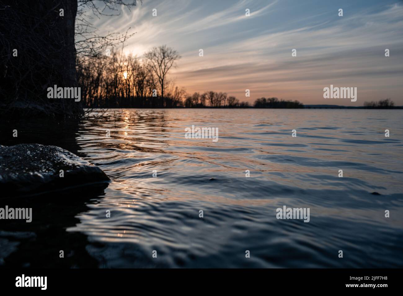 Mesmerizing view of a sunset in summer landscape, lake surrounded by ...