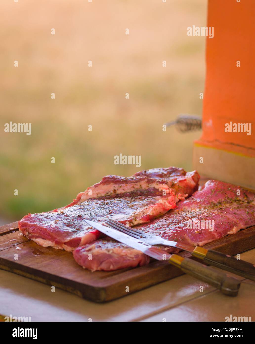 Large piece of raw red meat ready to be grilled. Typical argentinian food, asado. Stock Photo