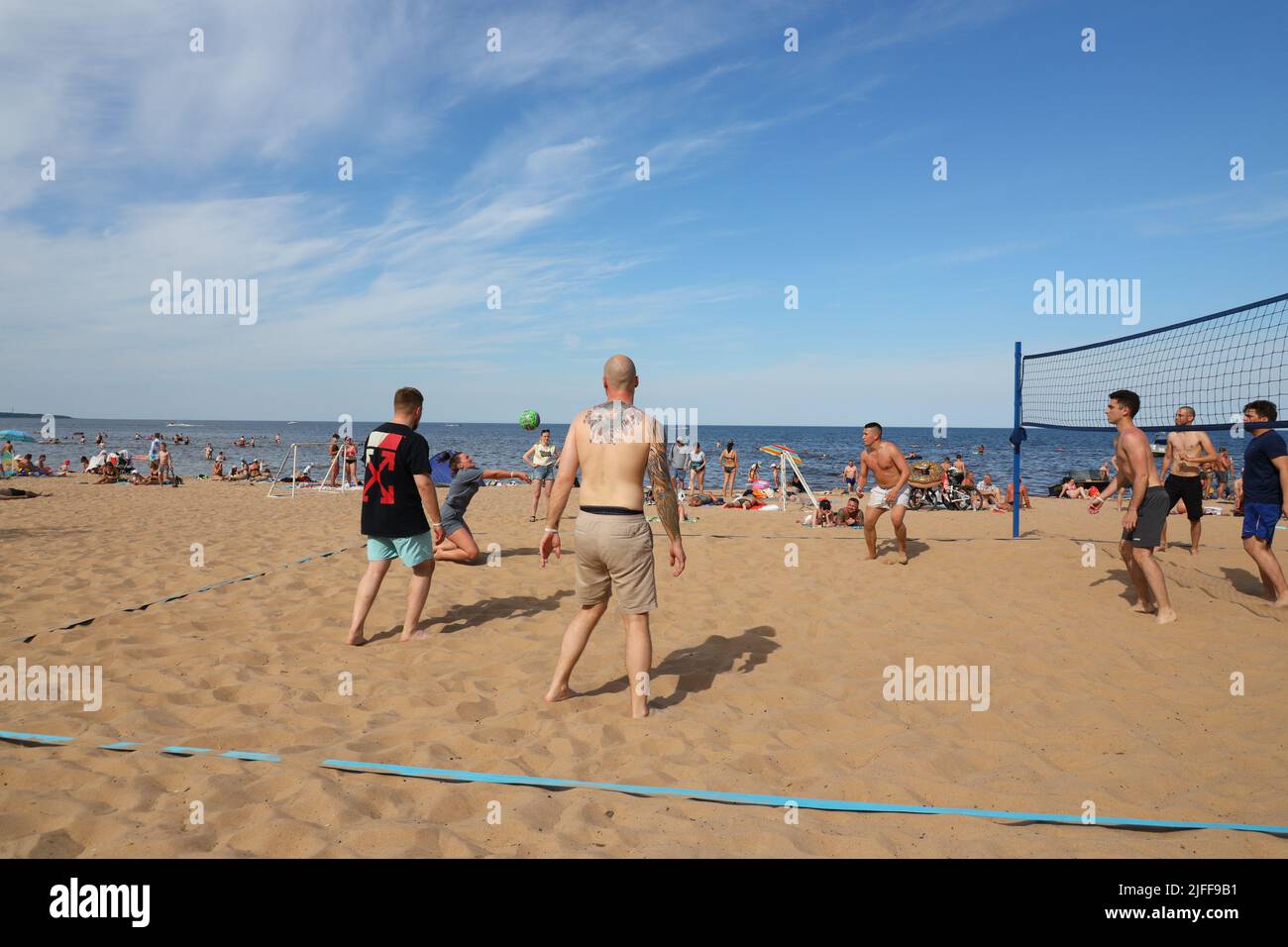 Photograph of people playing beach volleyball in summer Stock Photo
