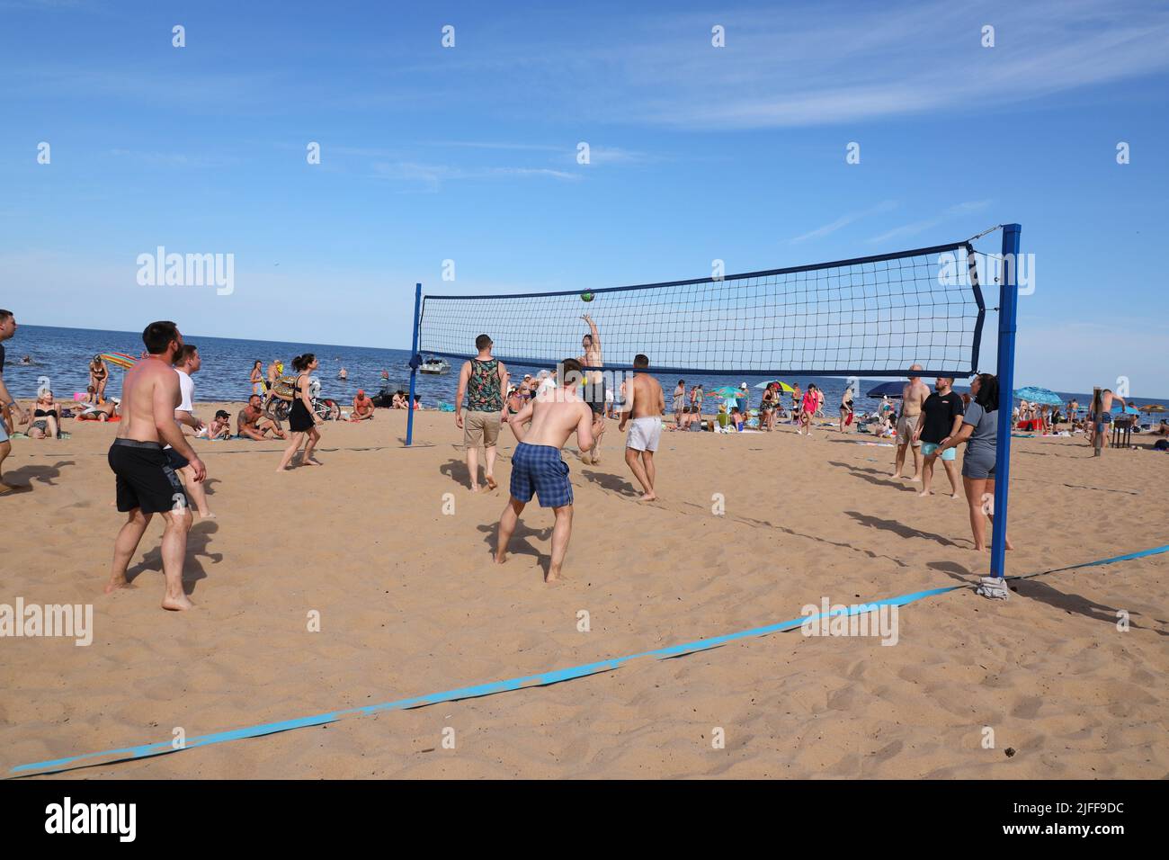 Photograph of people playing beach volleyball in summer Stock Photo