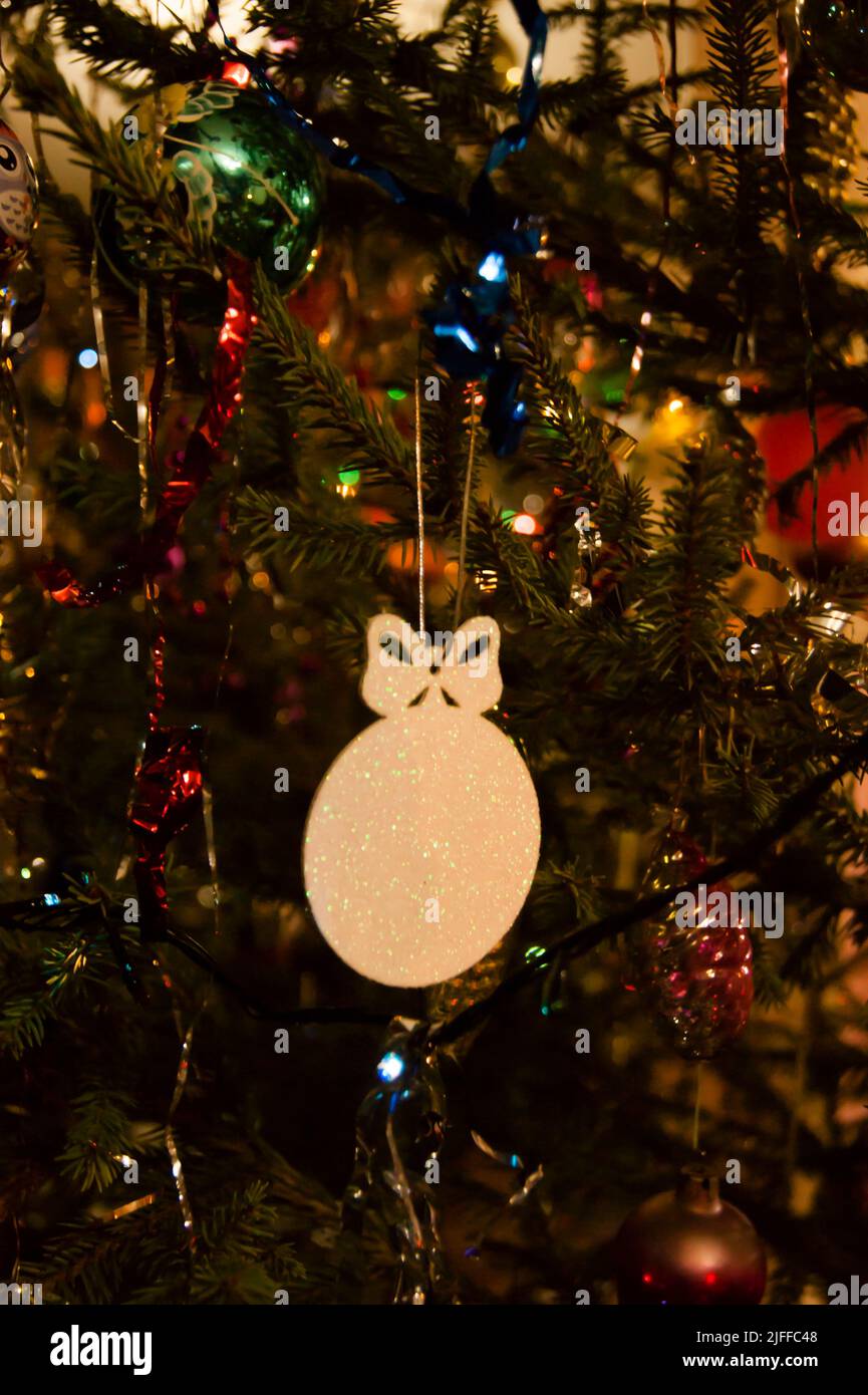 The holiday is a new year or Christmas, in the photo a live fir tree is decorated with toys, tinsel and beads. Retro. - Stock Image