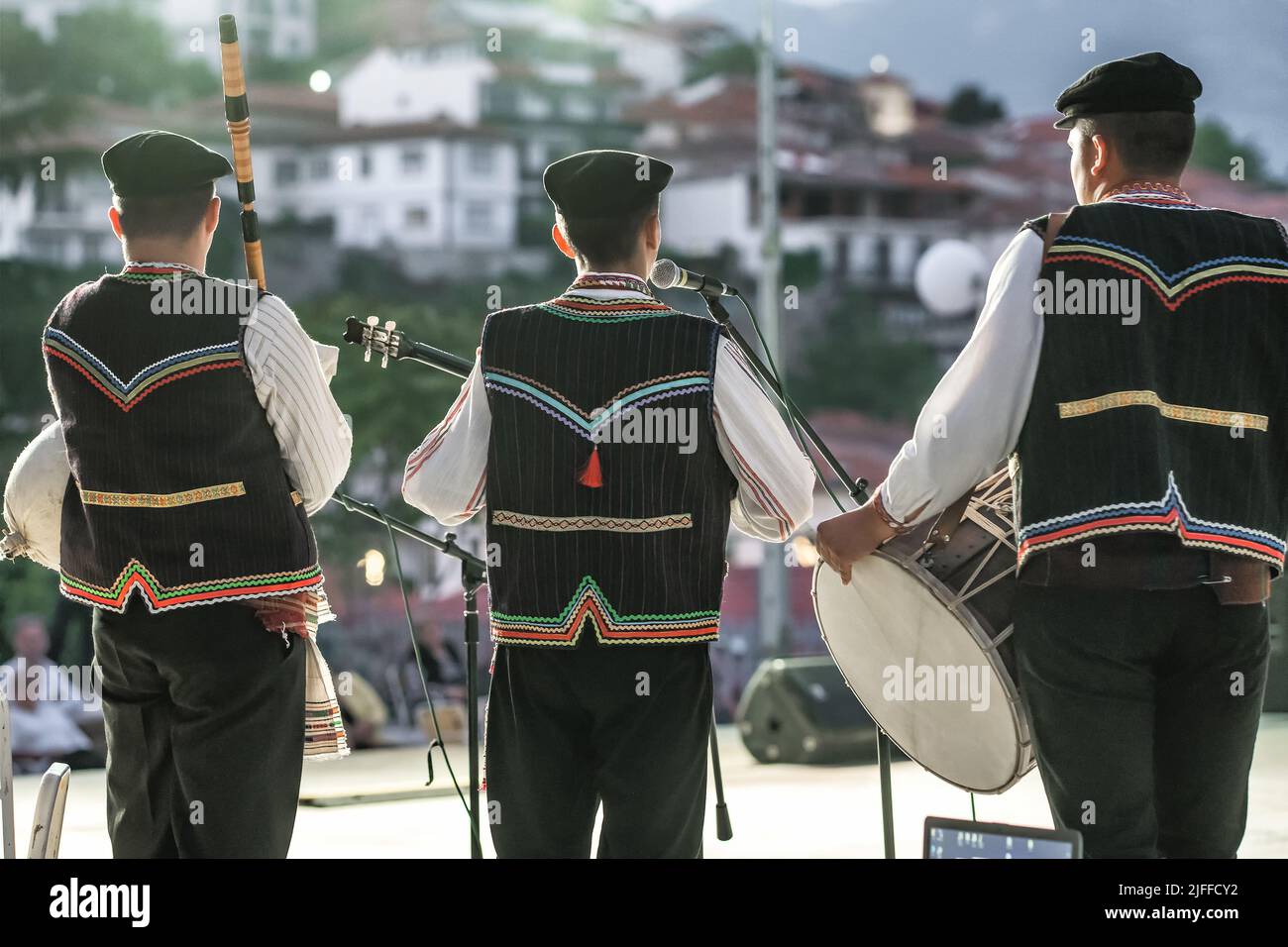 Unidentified Macedonian musicians in traditional costumes perform at folk music festival in Northern Macedonia. Stock Photo