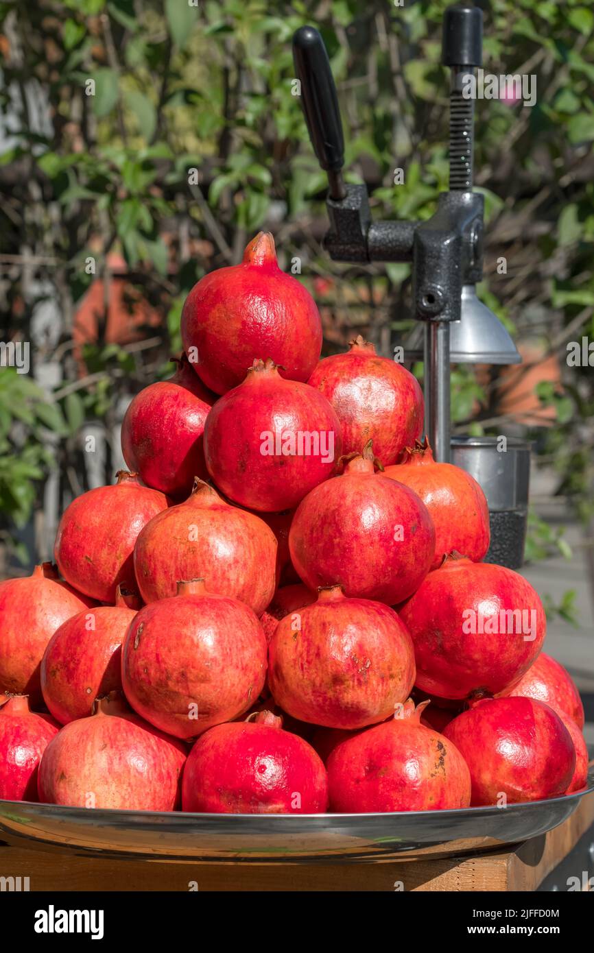 Pile of the fresh ripe pomegranates in small street food stall Stock Photo