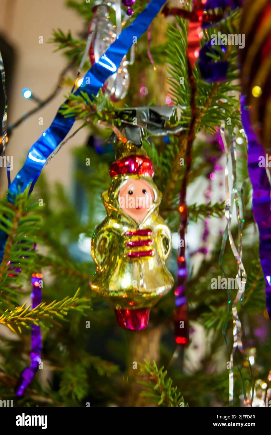 The holiday is a new year or Christmas, in the photo a live fir tree is decorated with toys, tinsel and beads. Retro. - Stock Image