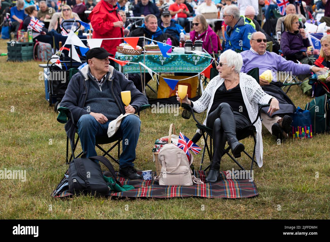 Woodstock, Oxfordshire, UK. 2nd July 2022. Couple with drings and Union Jack. Battle Prom Picnic Concerts. Blenheim Palace. United Kingdom. Credit: Alexander Caminada/Alamy Live News Stock Photo