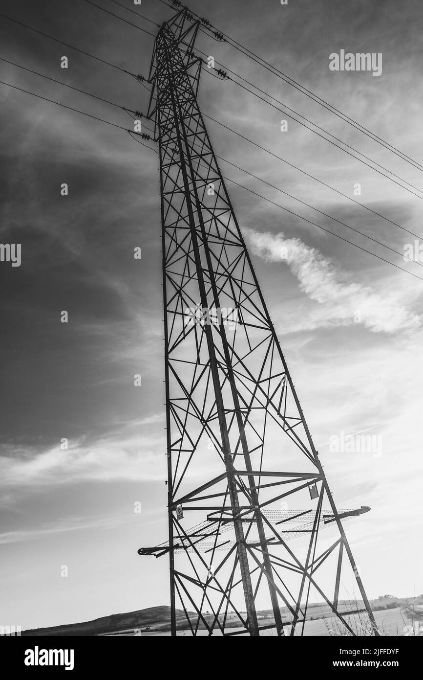 A vertical greyscale low angle shot of a transmission tower Stock Photo ...
