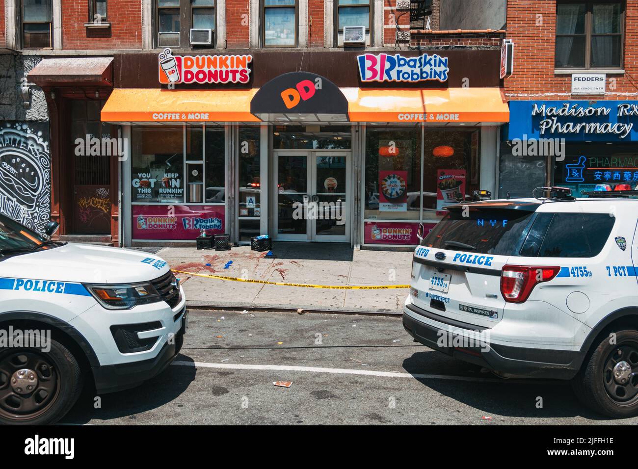 July 2, 2022: a crime scene in front of a Dunkin' Donuts in Manhattan's Lower East Side, New York City, after a man was shot in broad daylight Stock Photo