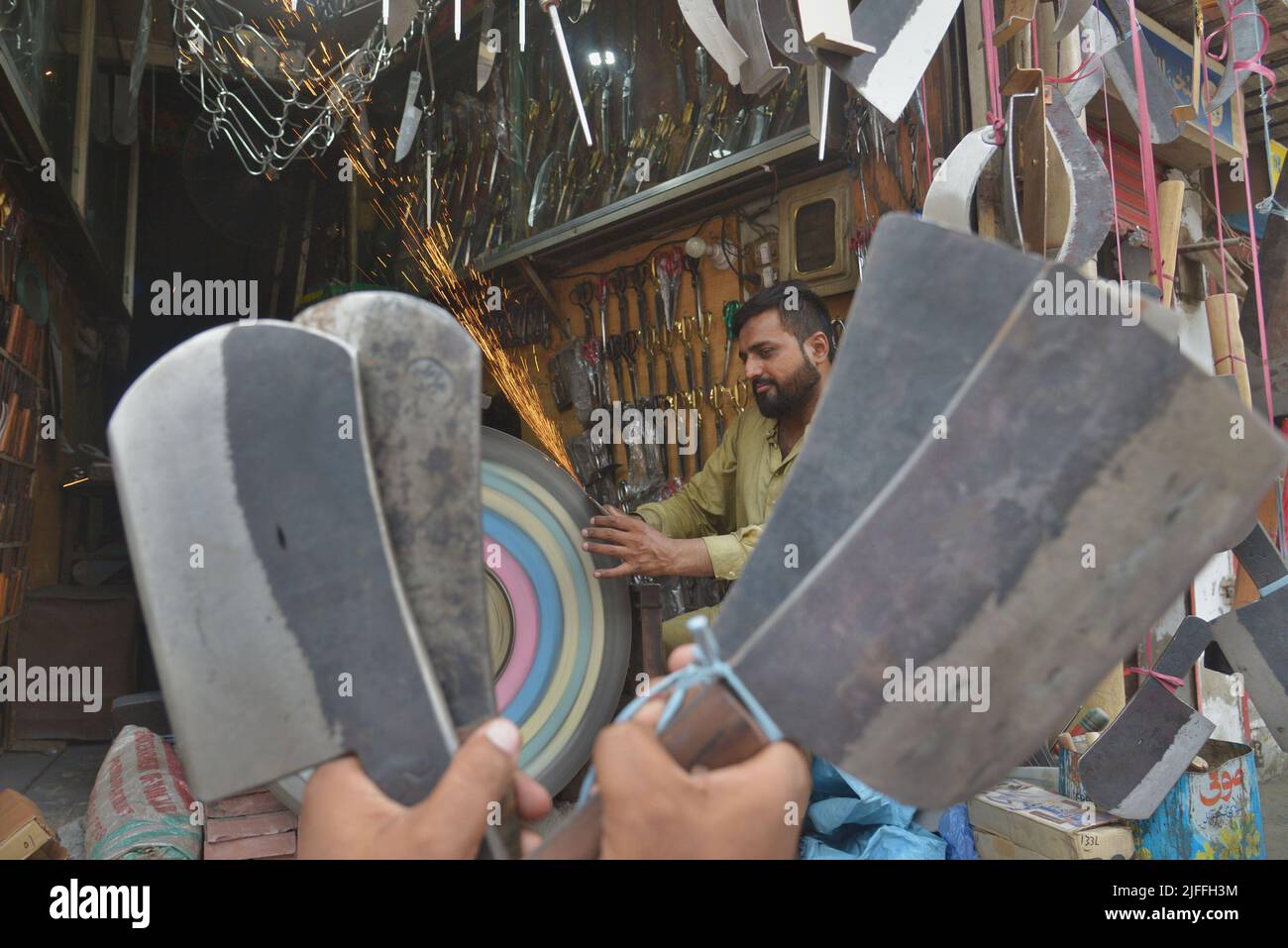 July 2, 2022, Lahore, Punjab, Pakistan Pakistani blacksmiths sharpens