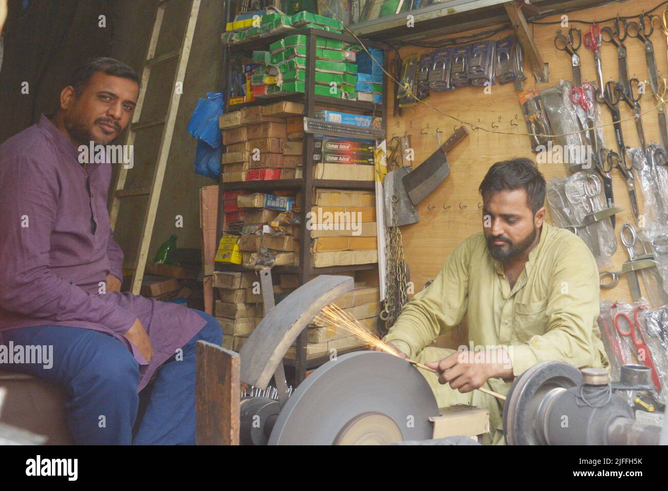 July 2, 2022, Lahore, Punjab, Pakistan Pakistani blacksmiths sharpens