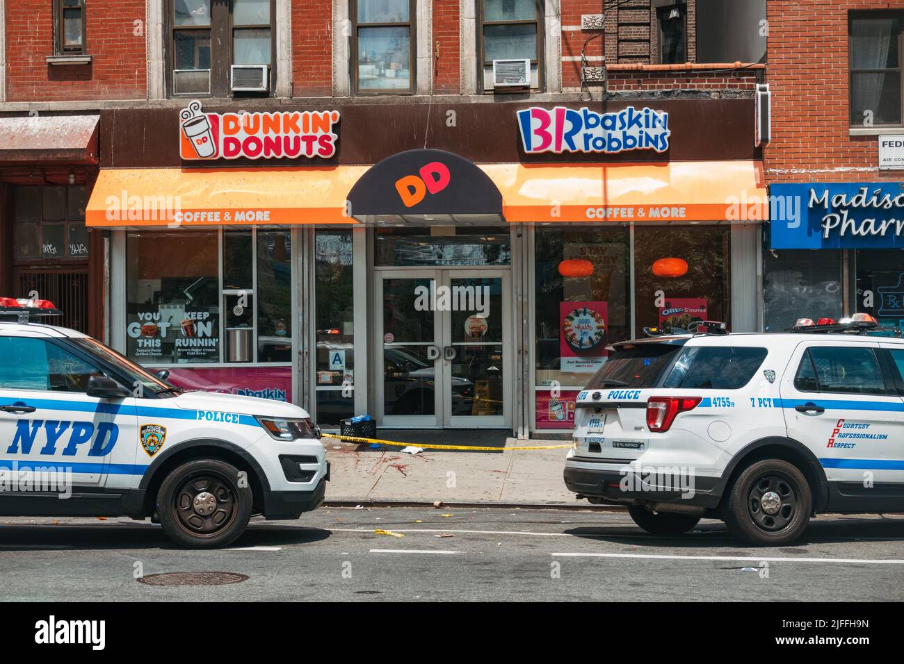 July 2, 2022: a crime scene in front of a Dunkin' Donuts in Manhattan's Lower East Side, New York City, after a man was shot in broad daylight Stock Photo