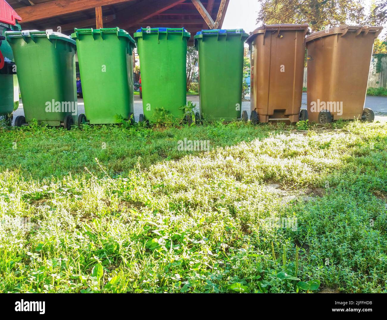 Garbage cans in different colors for waste management, trash recycling