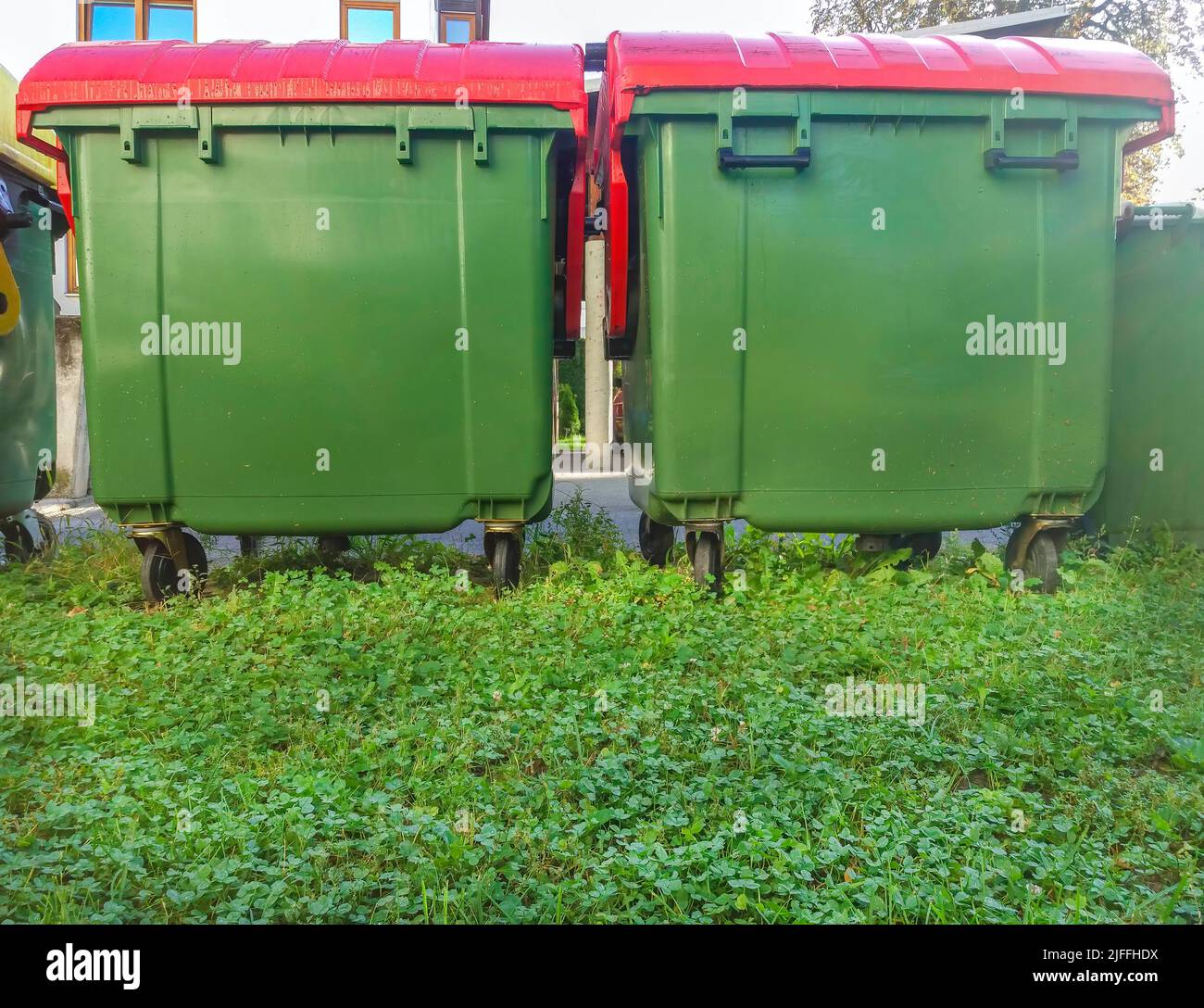 Garbage cans in different colors for waste management, trash recycling