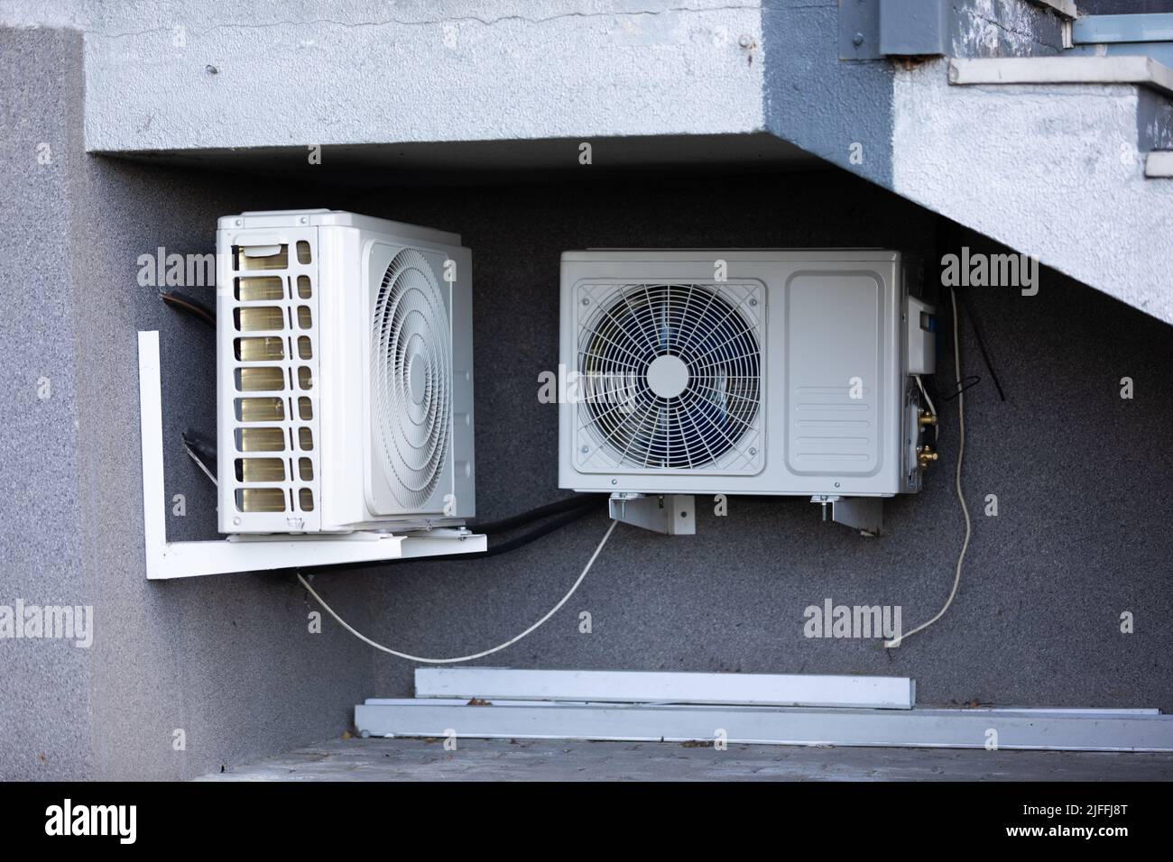 two units of outdoor air conditioners for heat dissipation are hung on