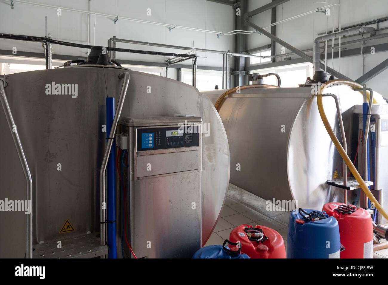 containers for storing milk after milking cows on a modern dairy farm