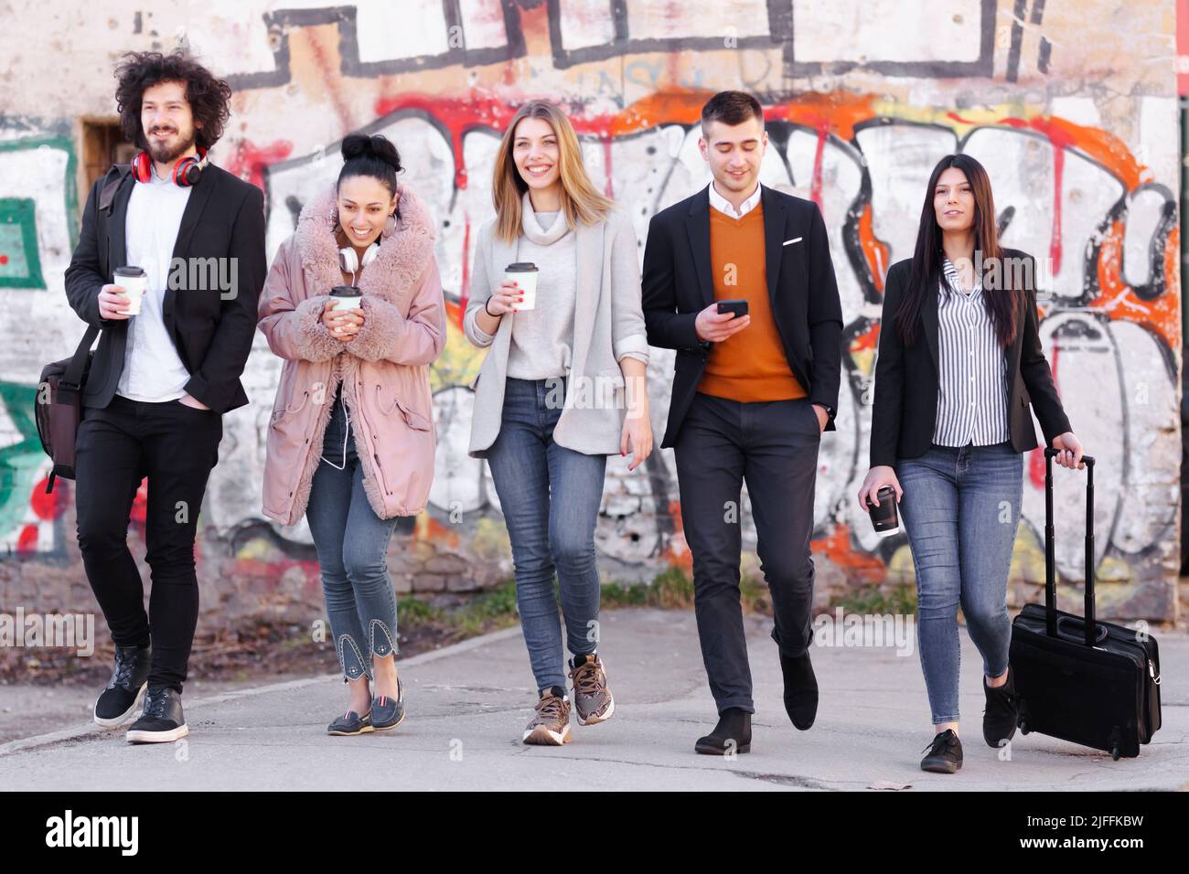 Group of people walking on a street with confidence. Businessmen and ...