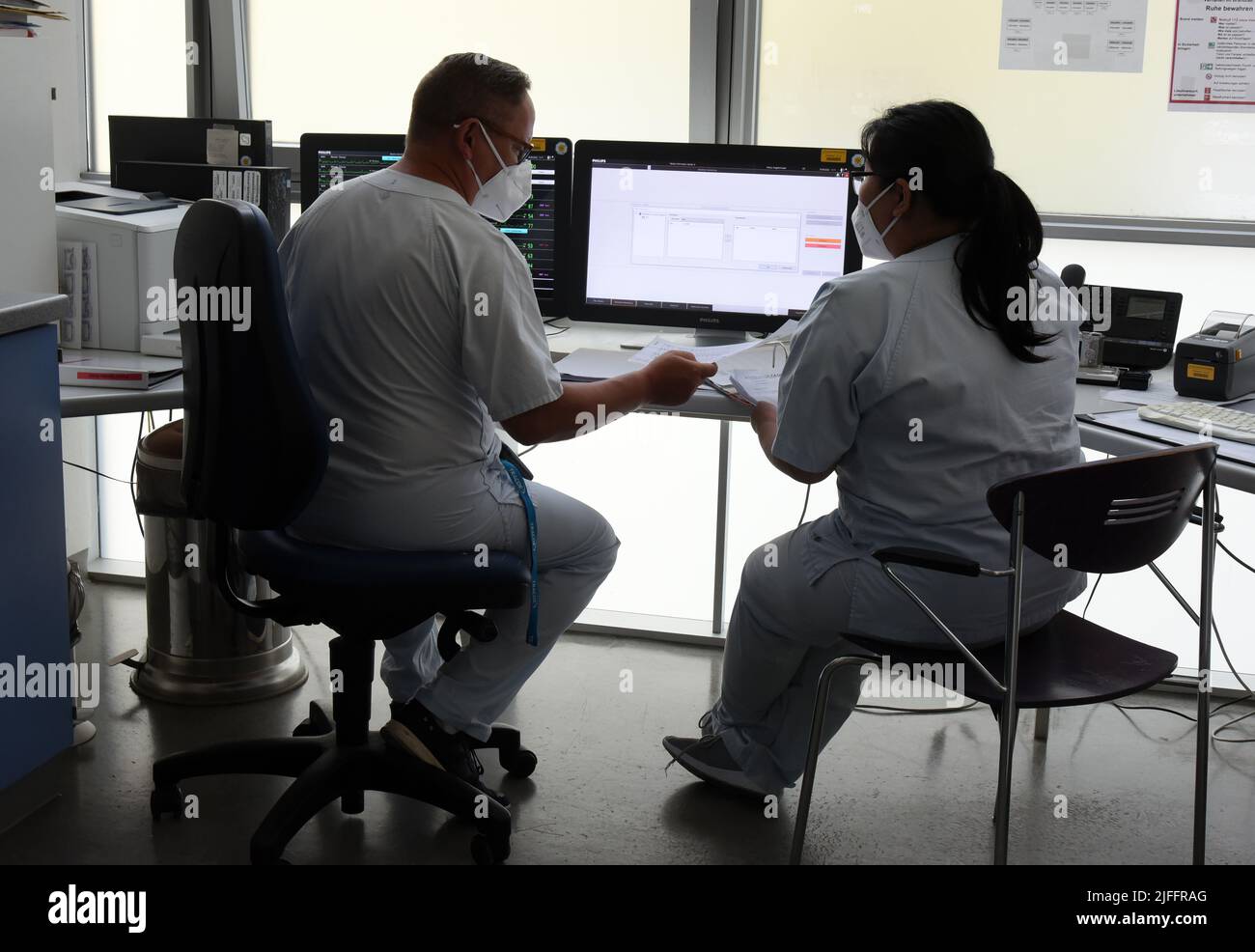 30 June 2022, Saxony, Leipzig: In the intensive care unit (ITS) at Klinikum St. Georg, ward manager Enrica Balder (l) consults with nurse Phuong Anh Luu Dao about the duty roster. The hospital is currently operating about a quarter fewer beds than in the pre-Corona era. The reason is staff shortages and the introduction of nursing staff floors, a spokeswoman said. In addition, there are repeated absences due to staff suffering from Covid. Especially in the intensive care areas and during operations, the shortage affects the ability to act. (to dpa 'Situation in Saxon hospitals is tense') Photo Stock Photo