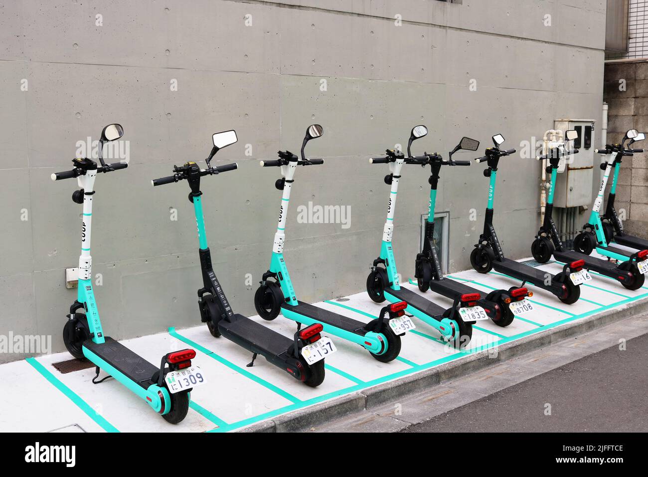 TOKYO, JAPAN - March 24th, 2022: Row of Luup rental e-scooters parked in  Tokyo's Aoyama area in Shibuya Ward Stock Photo - Alamy