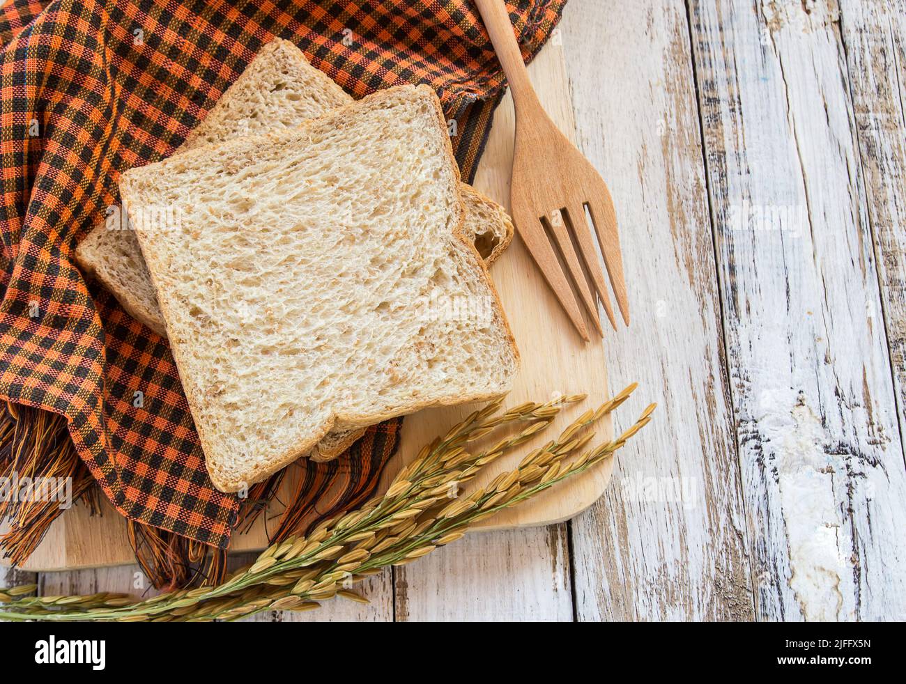 Whole wheat bread on white wooden table background Stock Photo - Alamy