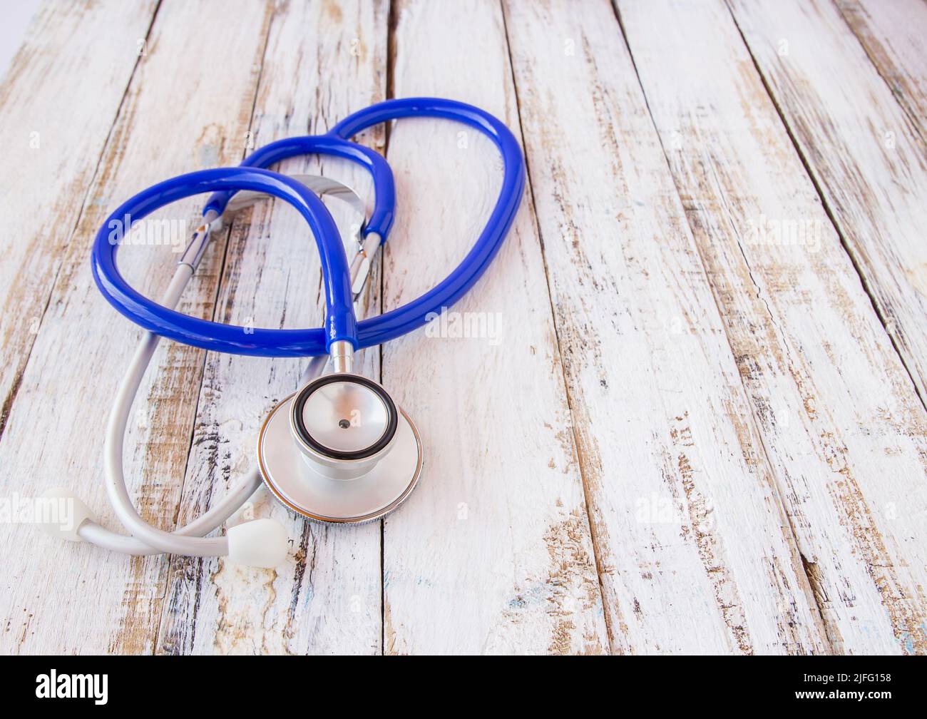 Stethoscope and book on white wooden table background Stock Photo - Alamy