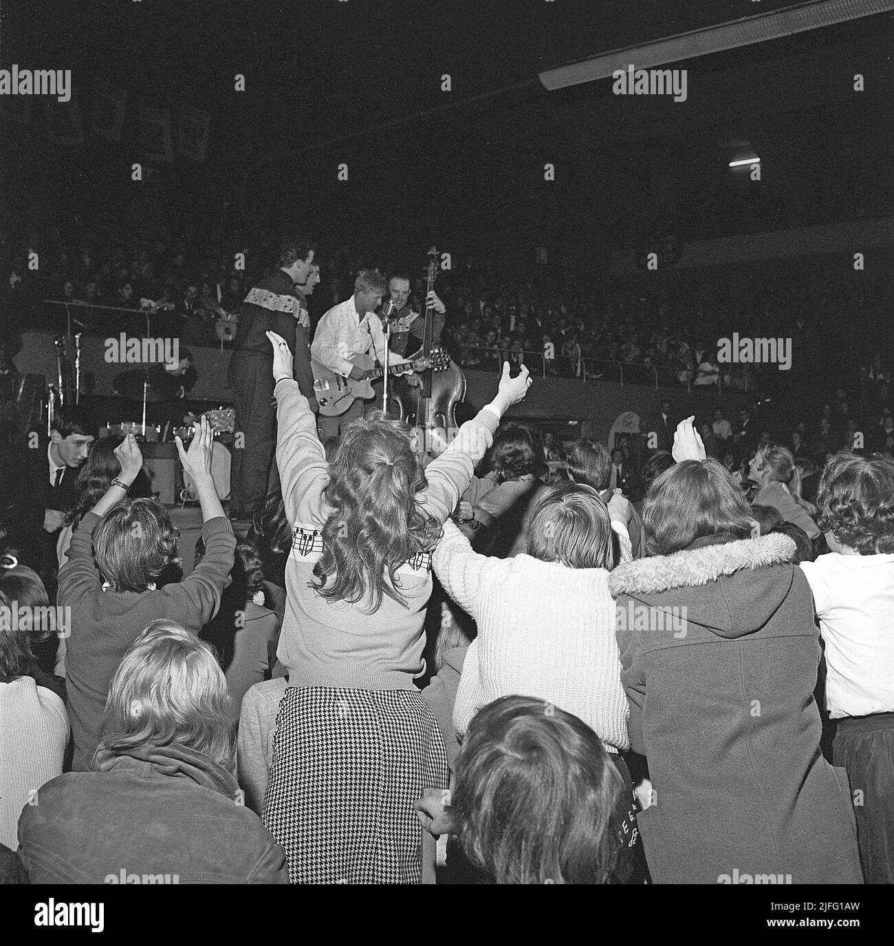 Tommy Steele. English entertainer regarded as Britain's first teen idol and rock and roll star. Born december 17 1936. Picture taken when he performed in Stockholm Sweden April 19 1958. The audience is visibly exited. Stock Photo