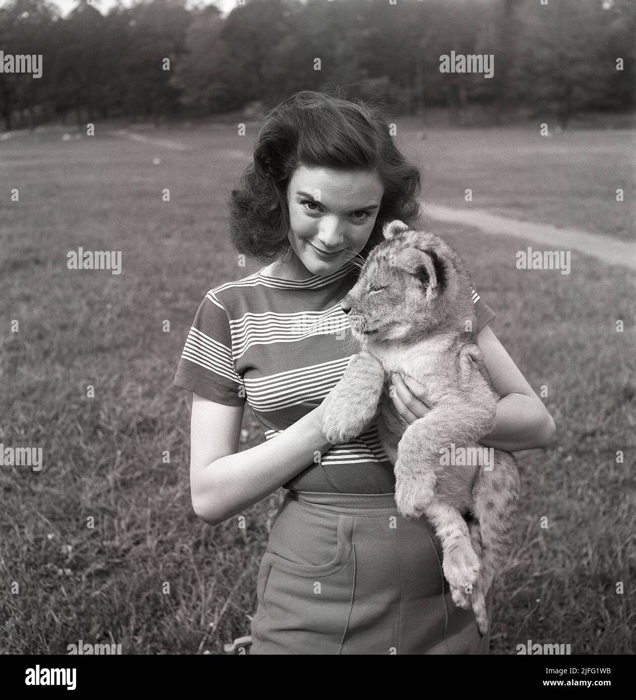 Doreen Denning. Swedish actress, 1928-2007. Pictured with a lion cub.  Sweden 1952. Kristoffersson ref BG15-8 Stock Photo