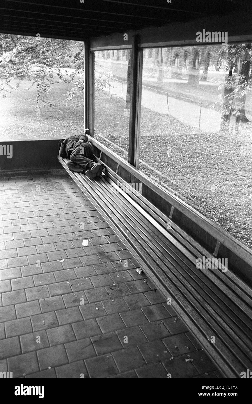 Homeless In The 1950s A Man Is Pictured Sleeping On The Bench At A Bus