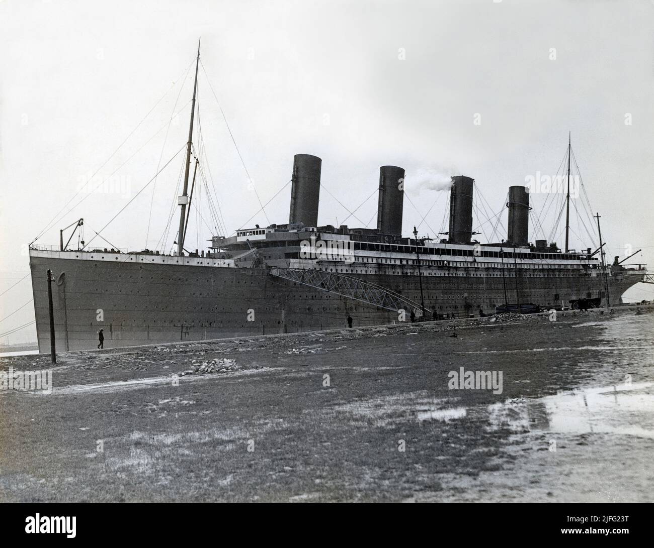 The Titanic. A British passenger liner operated by the White Star Line which sank in the North Atlantic Ocean on 15 April 1912 after striking an iceberg during her maiden voyage from Southampton to New York City. The Titanic was launched on 31 May 1911 and was towed to a fitting-out berth where over the course of the following year, engines, and interior was fitted out. The picture taken at Harland and Wolff in Belfast, Ireland in march 1912 during this time prior Titanic's sea trials and maiden voyage. Stock Photo