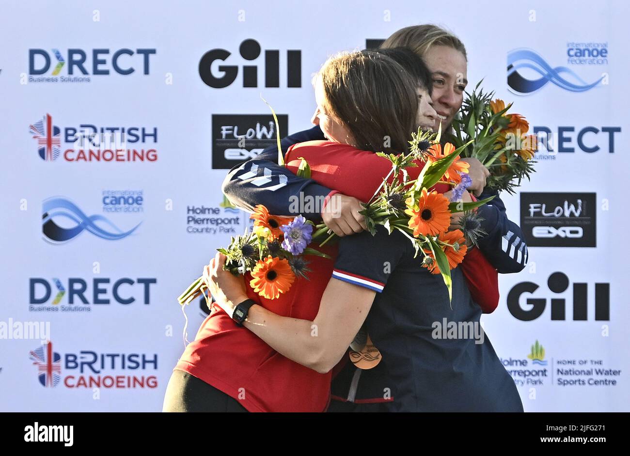 Nottingham, United Kingdom. 02nd July, 2022. The ICF 2022 canoe freestyle World Championships. National Water Sports Centre, Holme Pierrepont Country Park.All 3 medalists hug. (l to r) Hitomi Takaku (JPN, Silver), Ottilie Robinson-Shaw (GBR, Gold) and Marlene Devillez (FRA, Bronze) hug with their medals and flowers to celebrate during the medal presentation for the Women's Kayak Final. Credit: Sport In Pictures/Alamy Live News Stock Photo