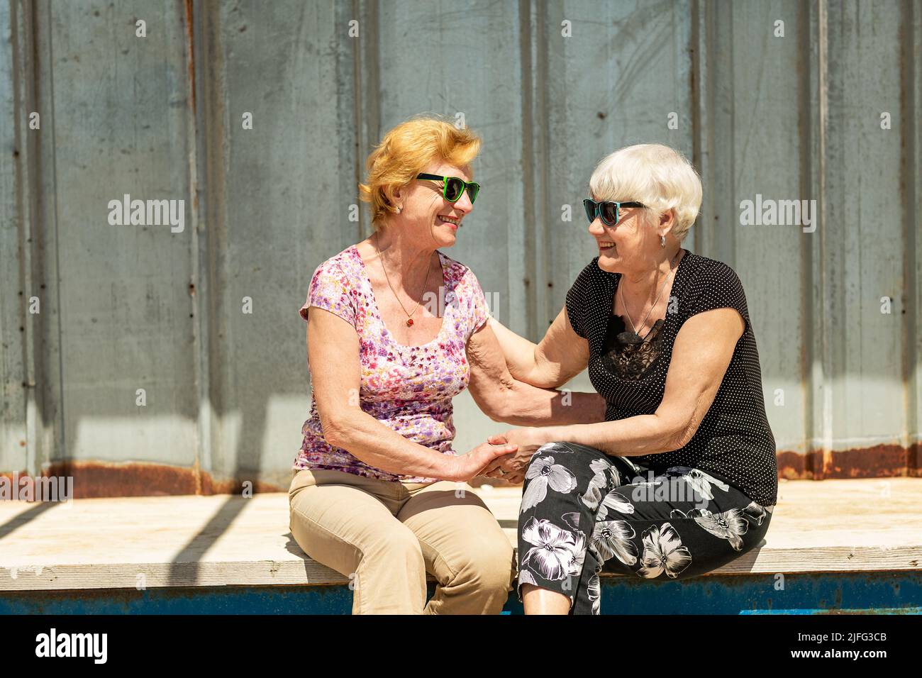 Two elderly women are happy to meet each other Stock Photo - Alamy