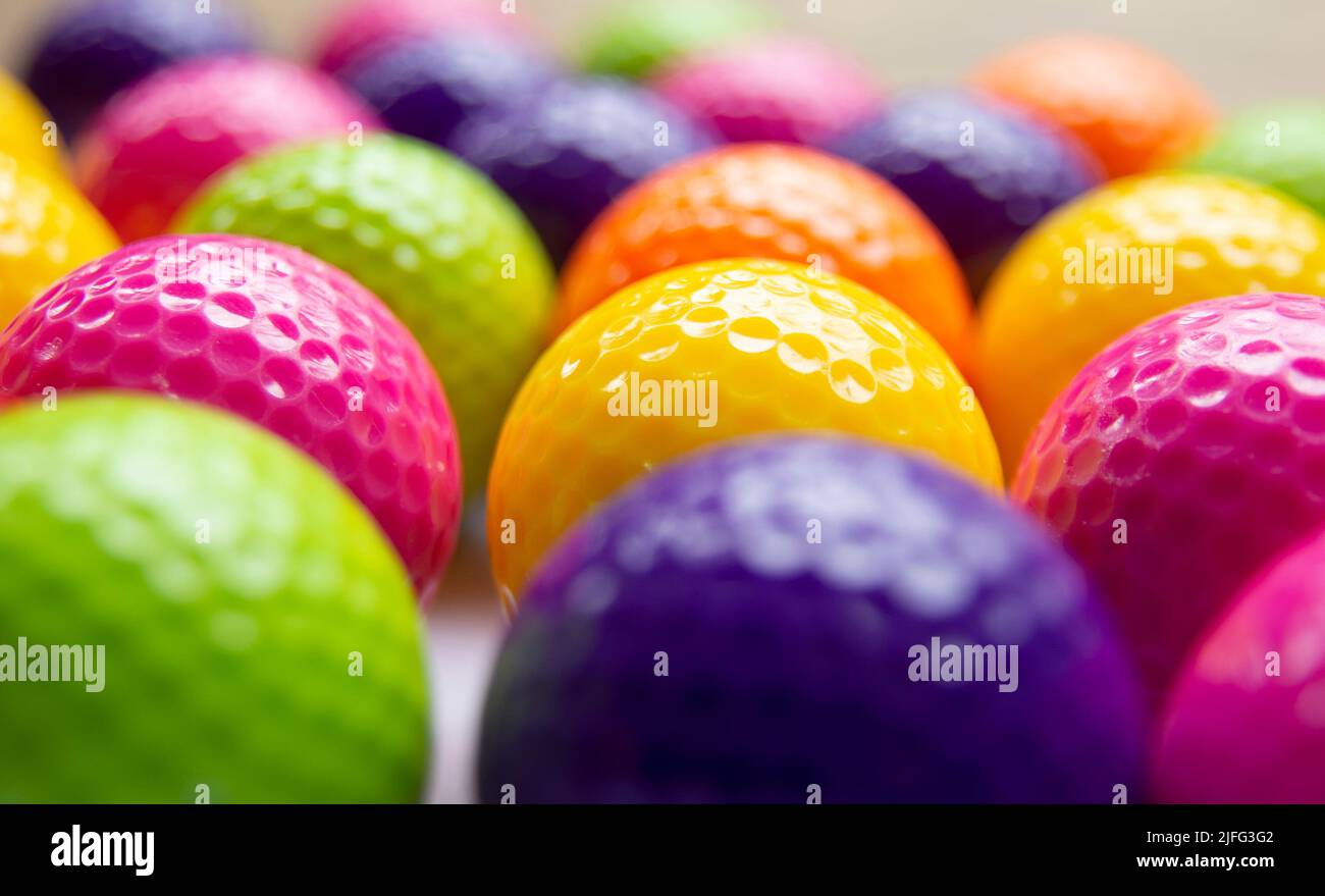 A full frame image of brightly coloured Mini golf balls in soft focus Stock Photo