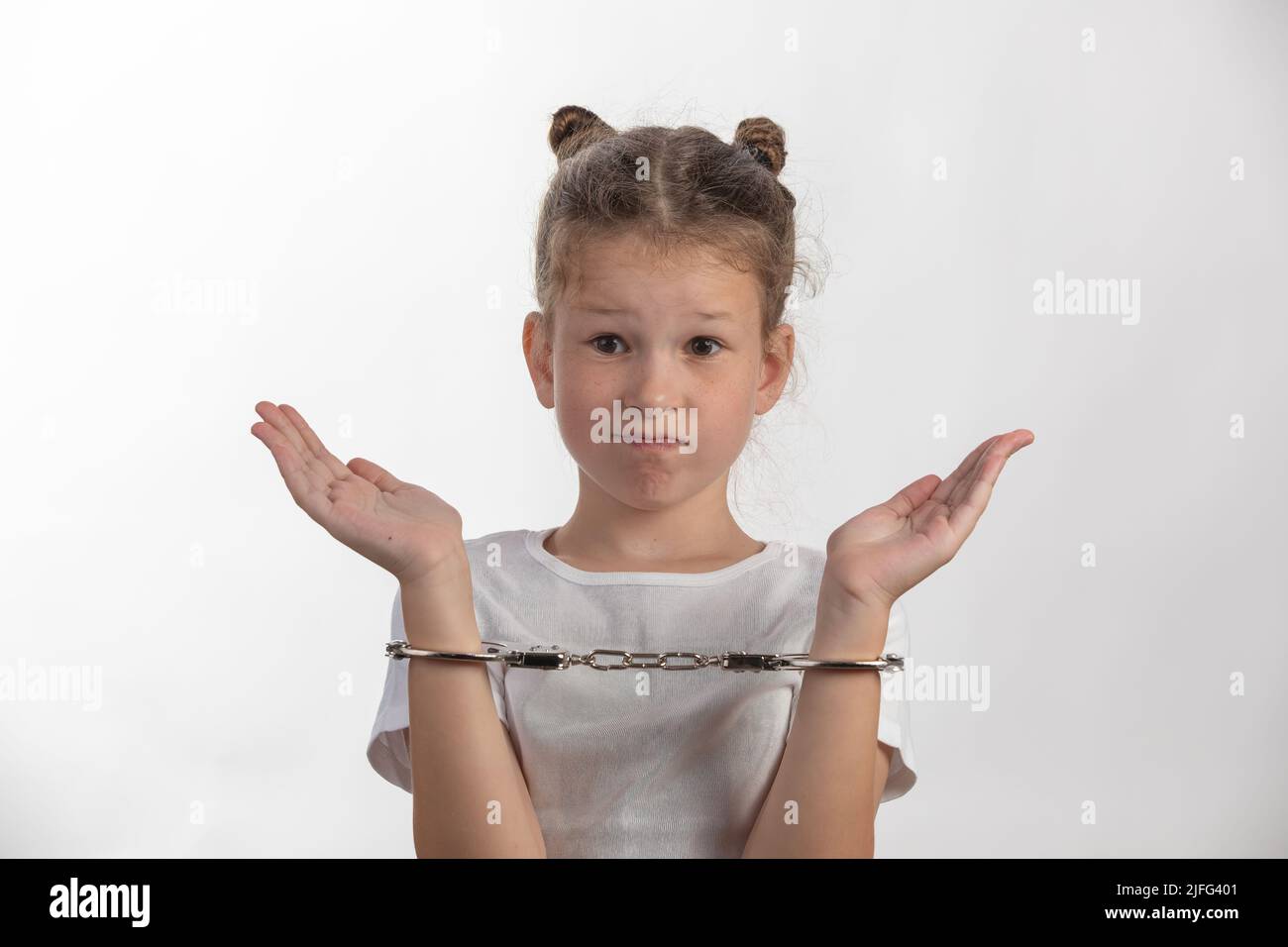 Young female escape artist - girl with handcuffs - a child in trouble Stock Photo