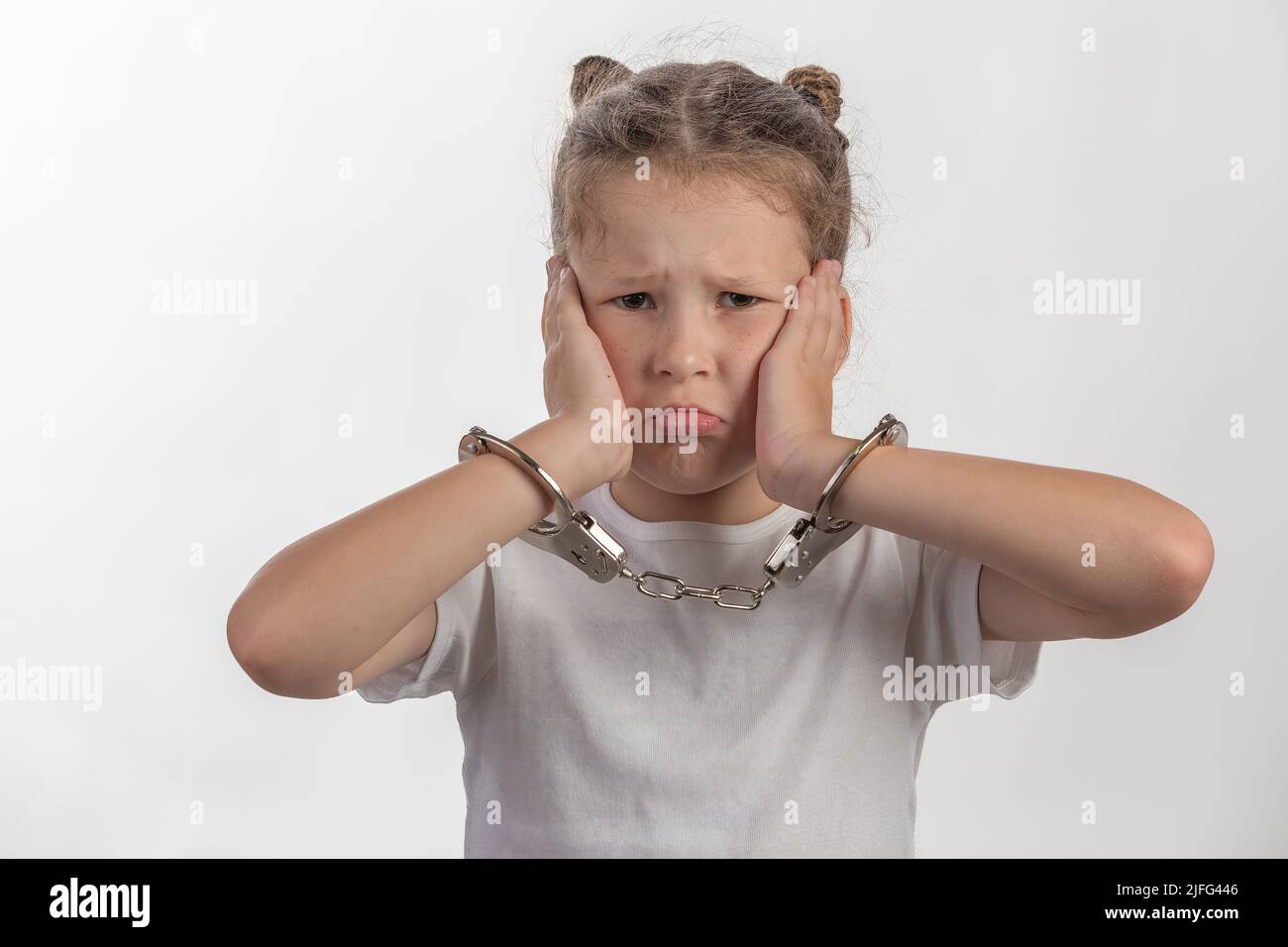 Young female escape artist - girl with handcuffs - a child in trouble Stock Photo