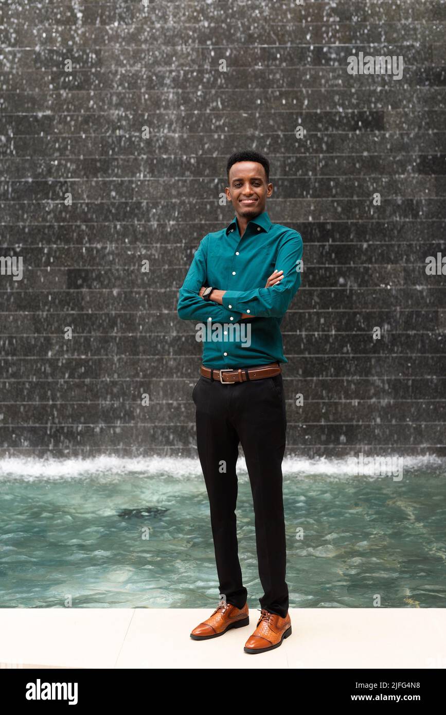 Portrait of handsome young black man outdoors during summer Stock Photo