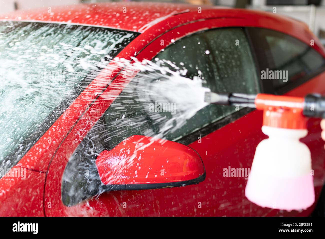 vehicle cleaning with pressure foam gun Stock Photo Alamy
