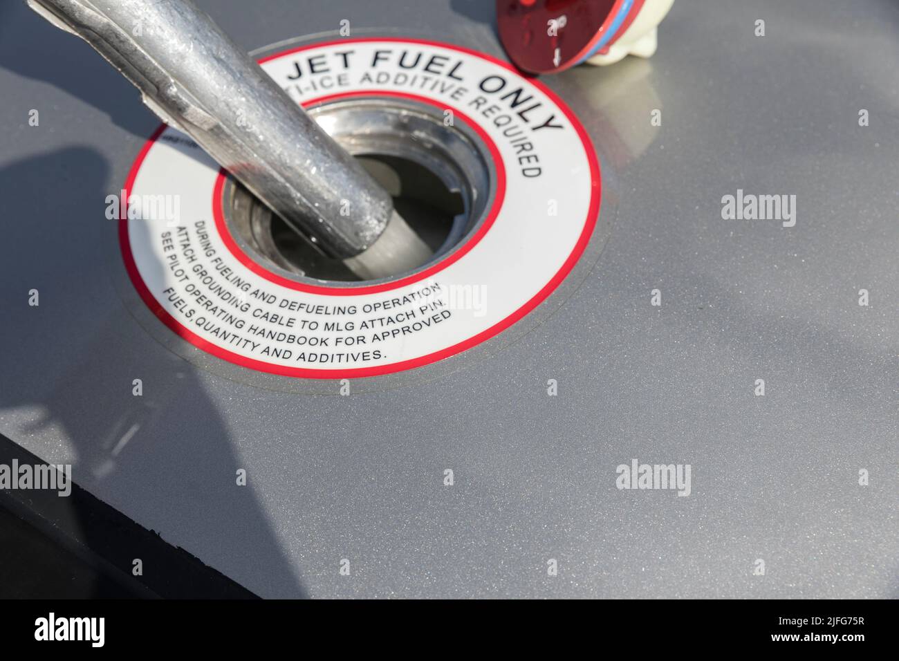 A closeup view of the aircraft's fuel tank, fuel is being filled into