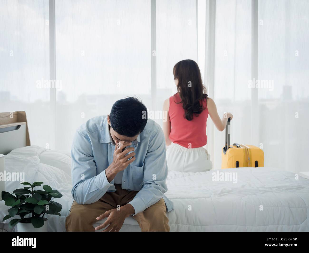 The anxiety of Asian couple lovers on the bed. Stressed man and young ...