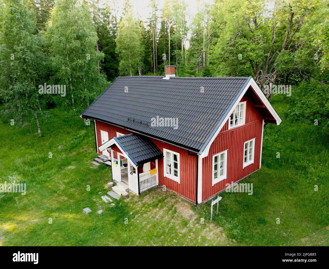 An aerial view of a house in a forest surrounded by green nature Stock ...